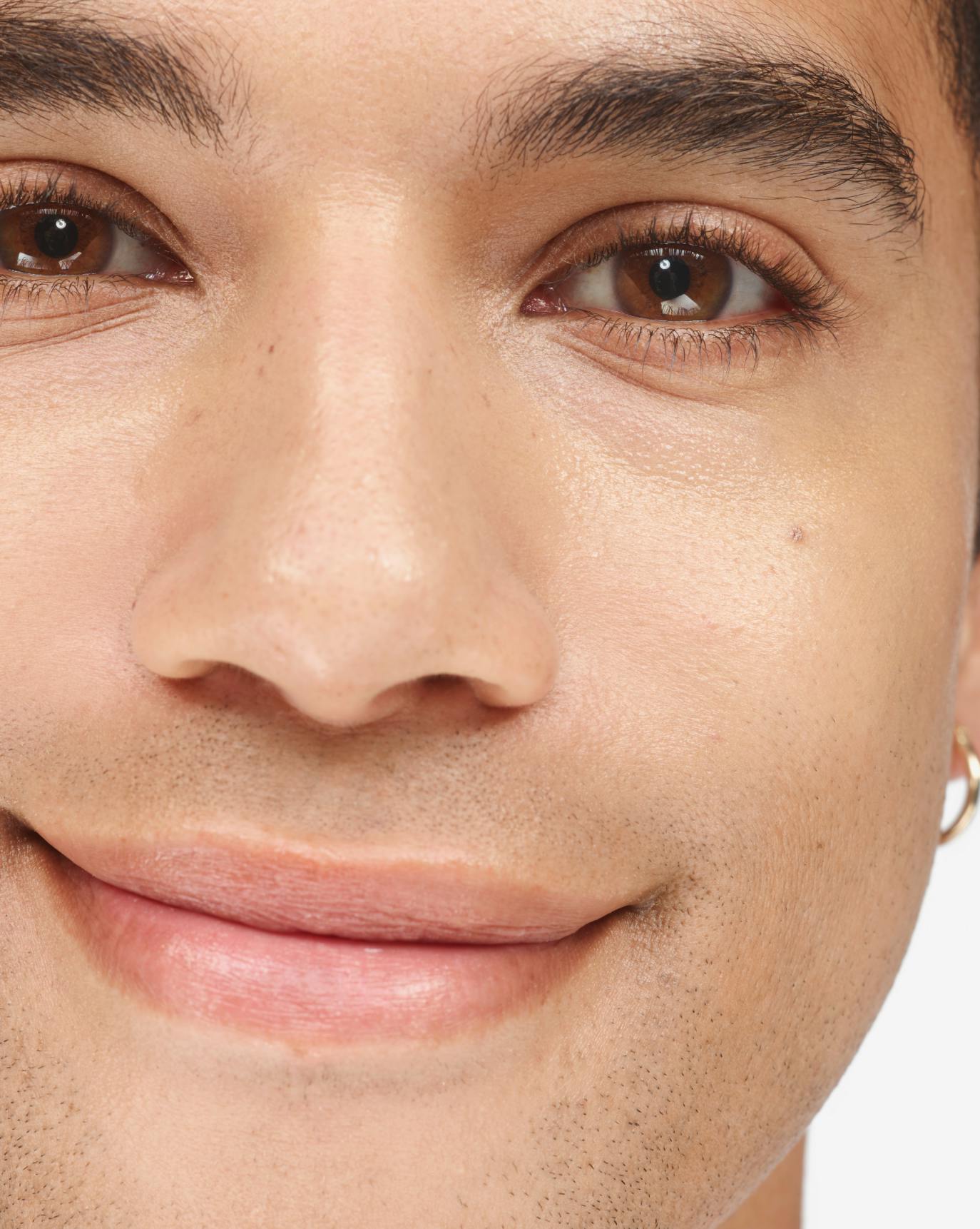 DJ applies Stretch Balm Concealer in M2.