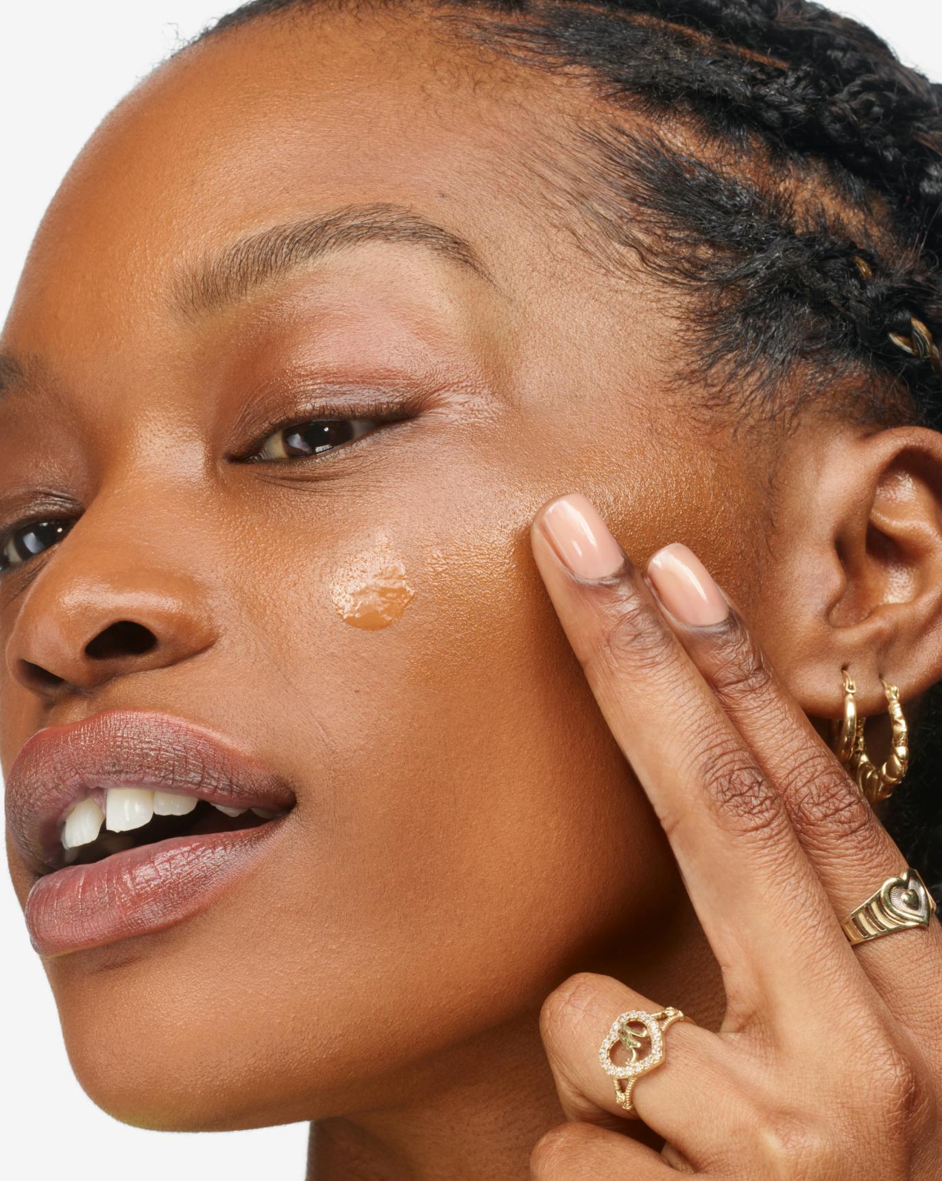 Mecca applies Stretch Fluid Foundation in D1.