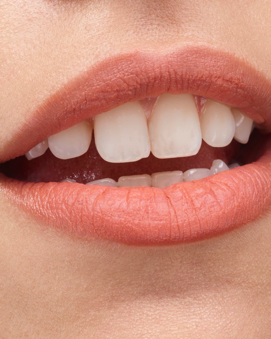 close up image of mouth wearing cake