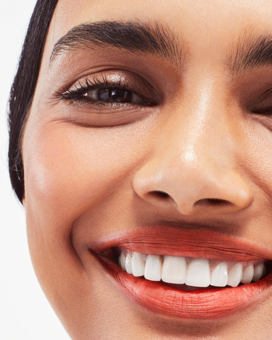 close up of face smiling wearing generation g in zip on lips