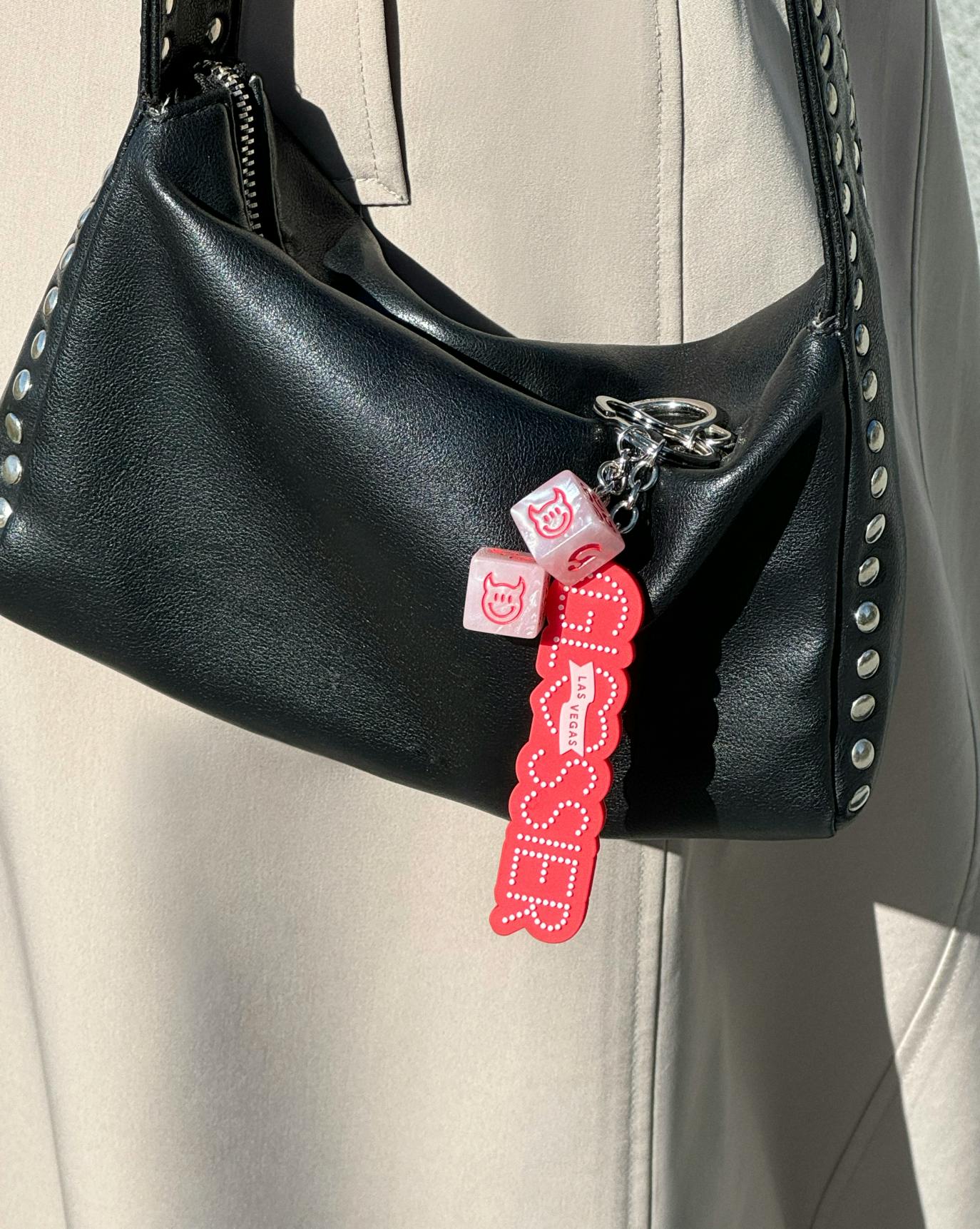 las vegas keychain attached to black purse