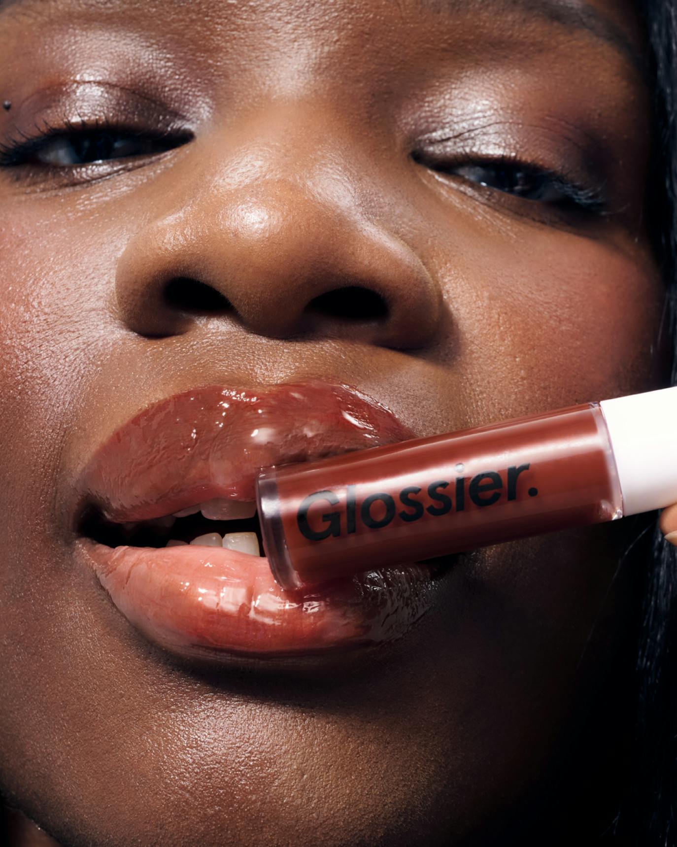 Marie model wears Lip Gloss in Brown.