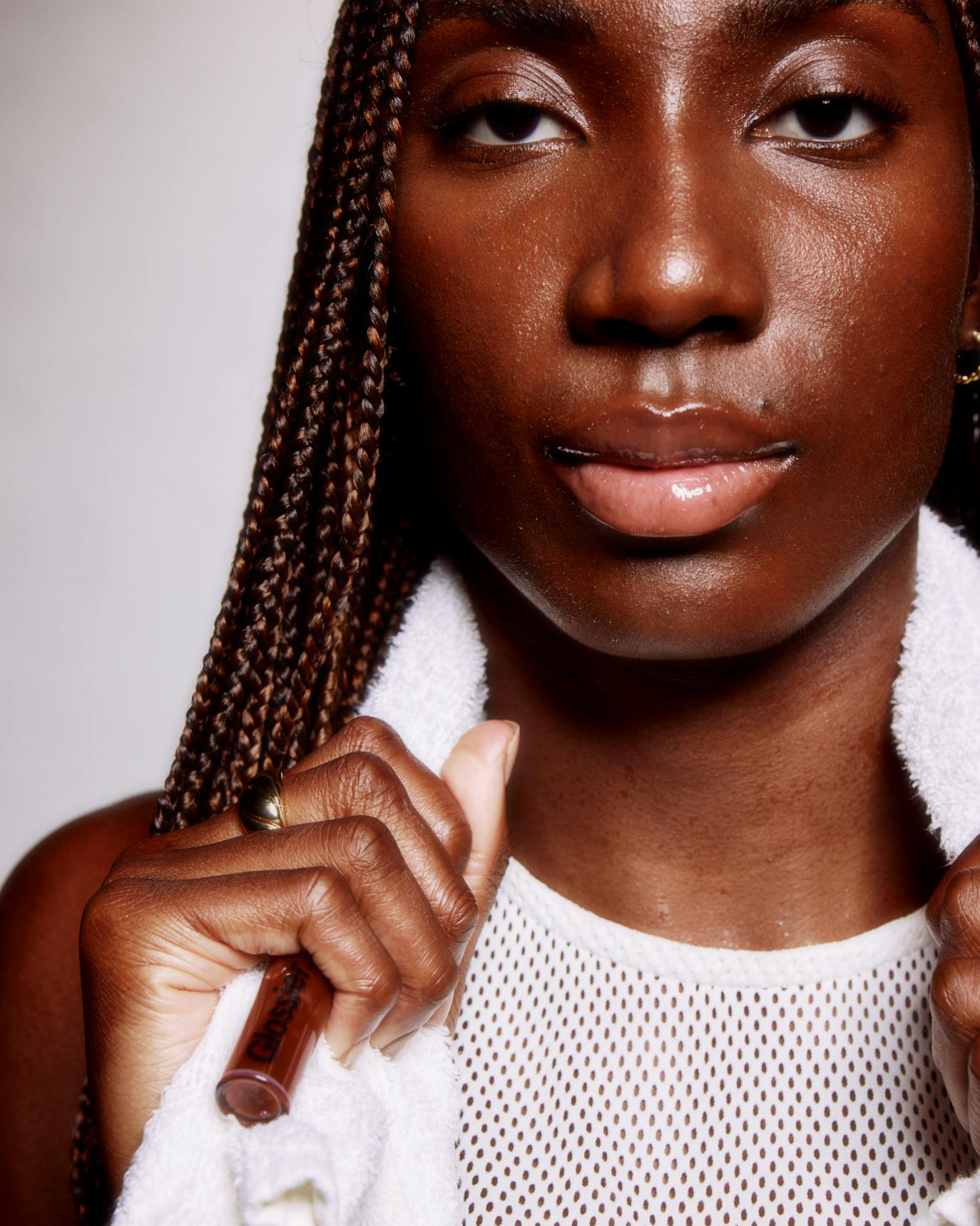 Ezi wears Lip Gloss in Brown.