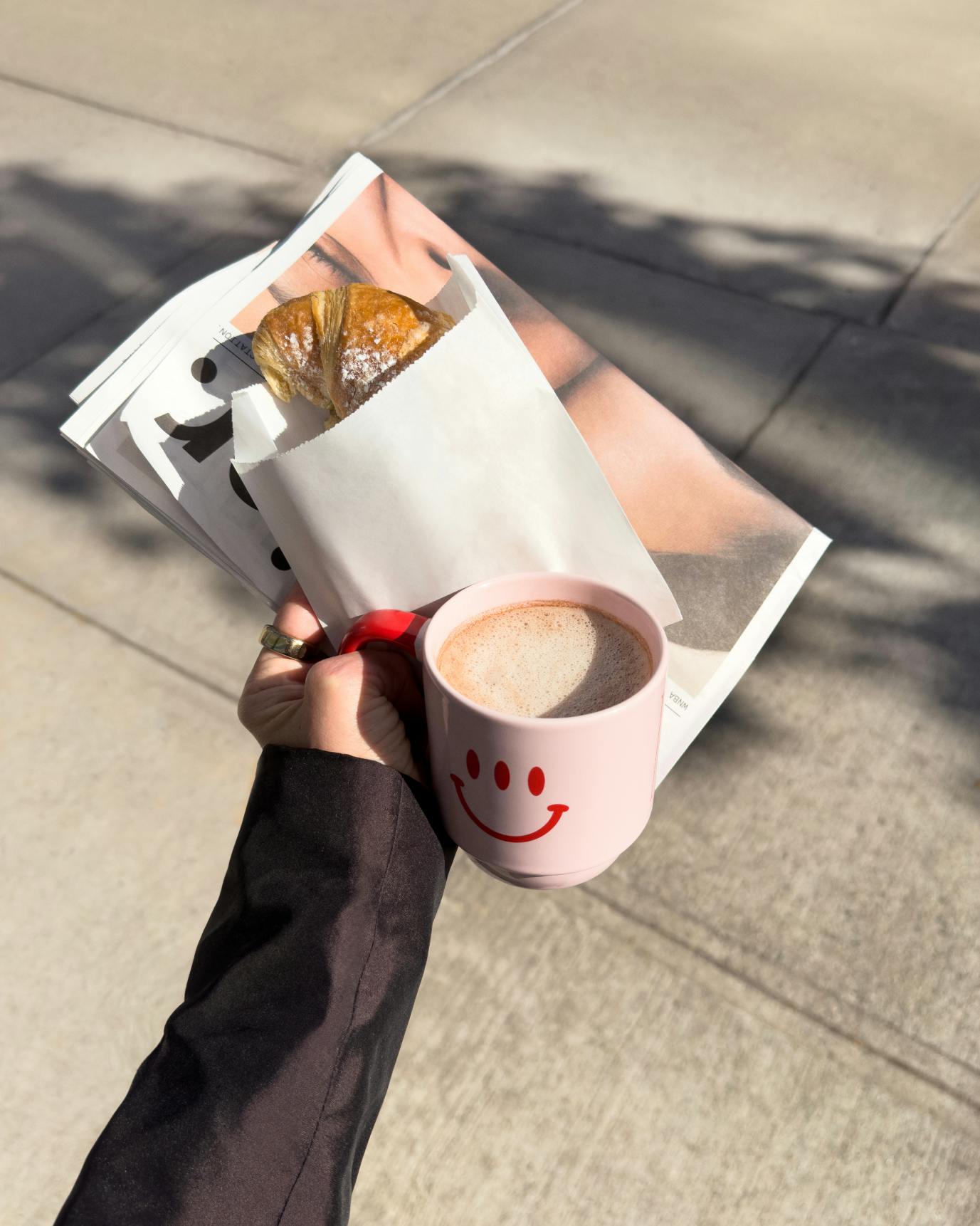 hand holding mug with papers