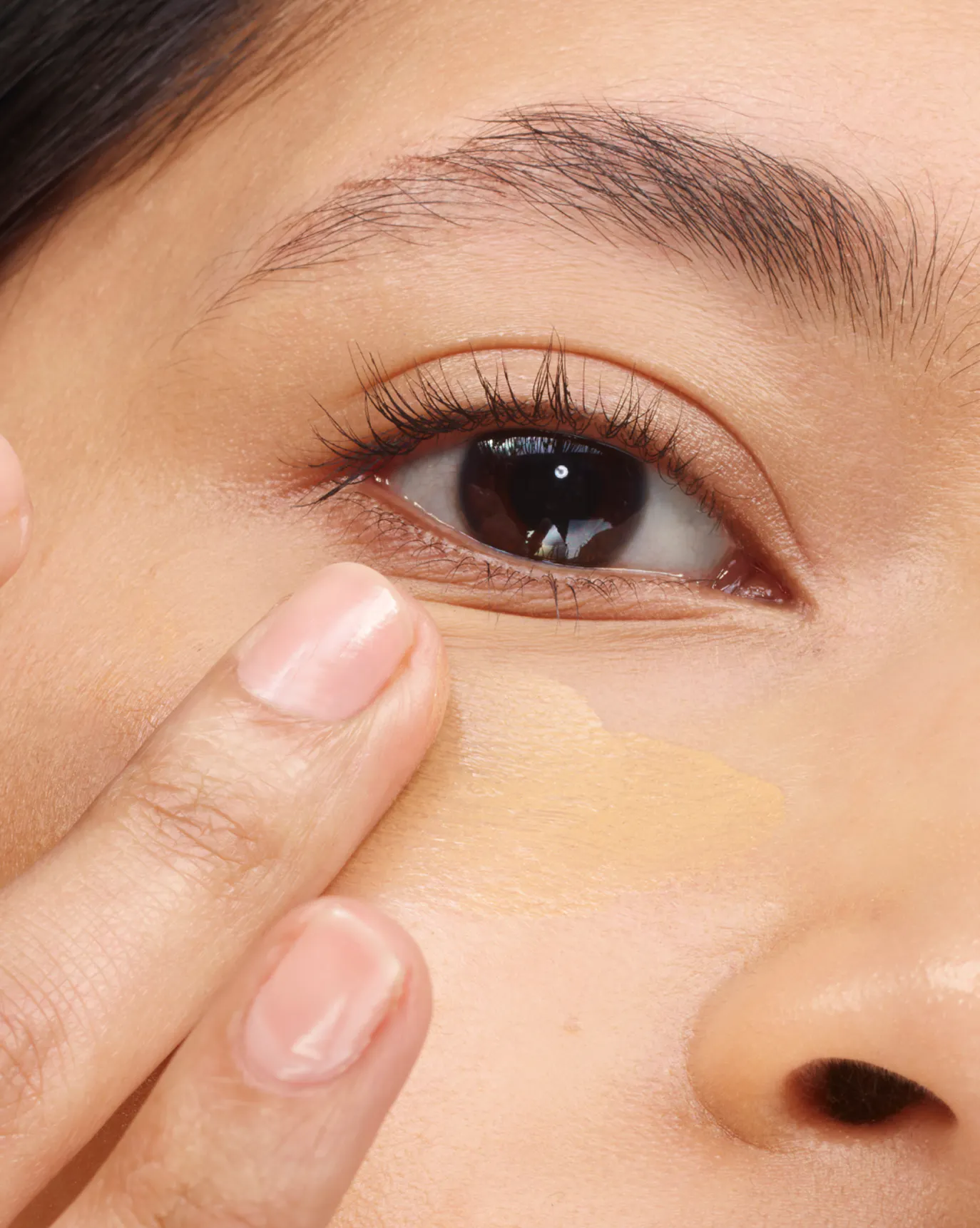 Thasfia wears Stretch Balm Concealer in MT1.