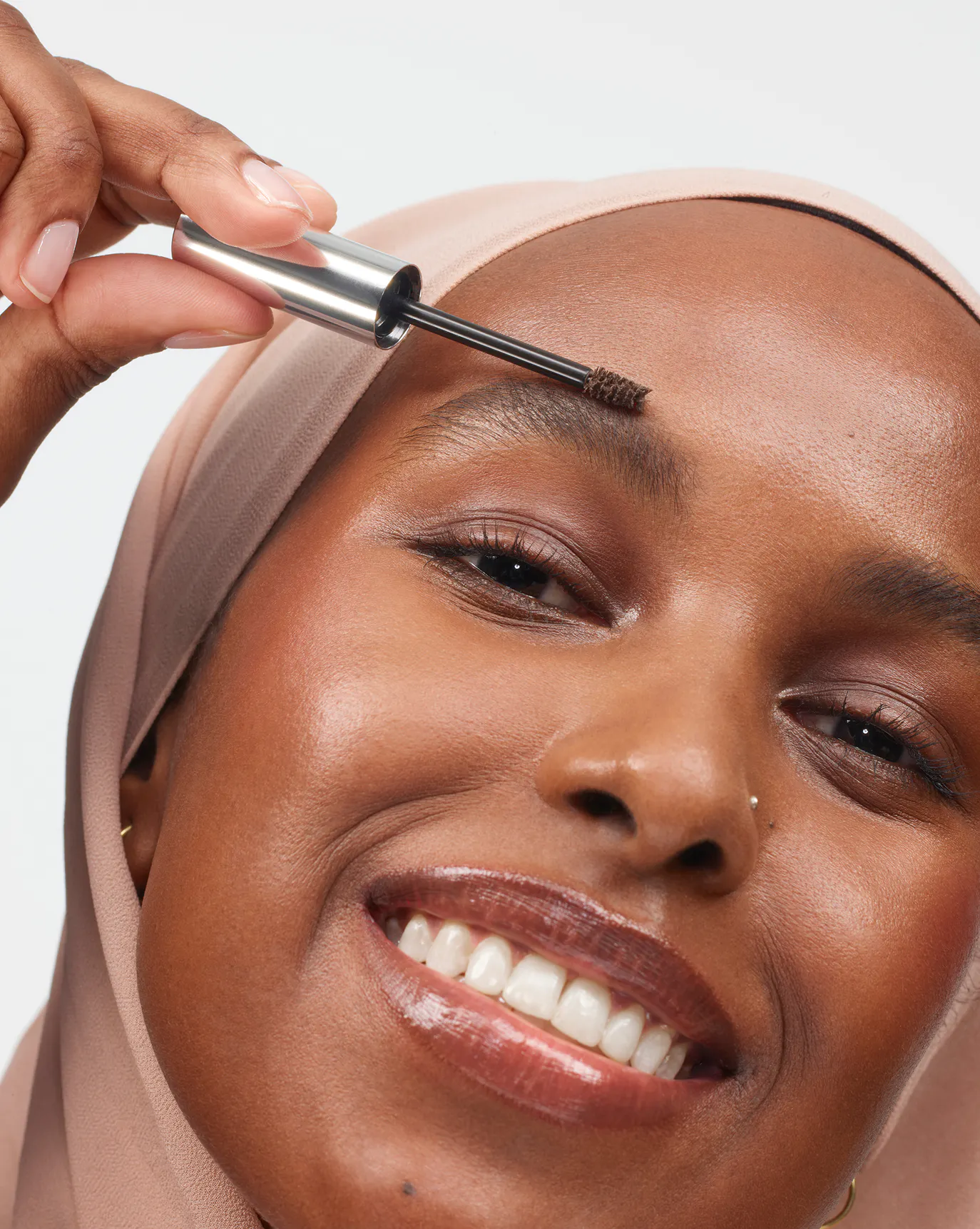 Nasra wears Boy Brow in Brown.