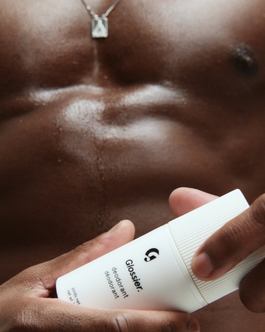 man holding glossier deodorant refillable case