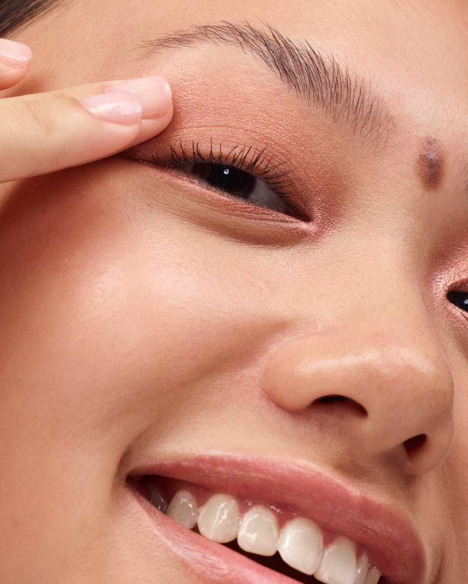 model applies monochromes in almond with finger